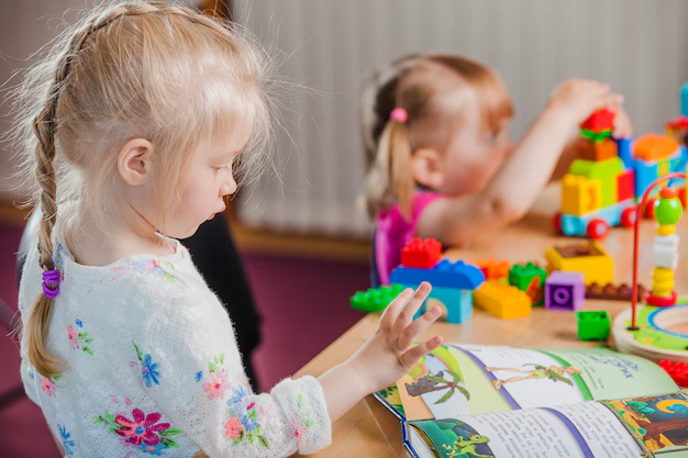 girls-with-book-colorful-toys_23-2147663359.jpg