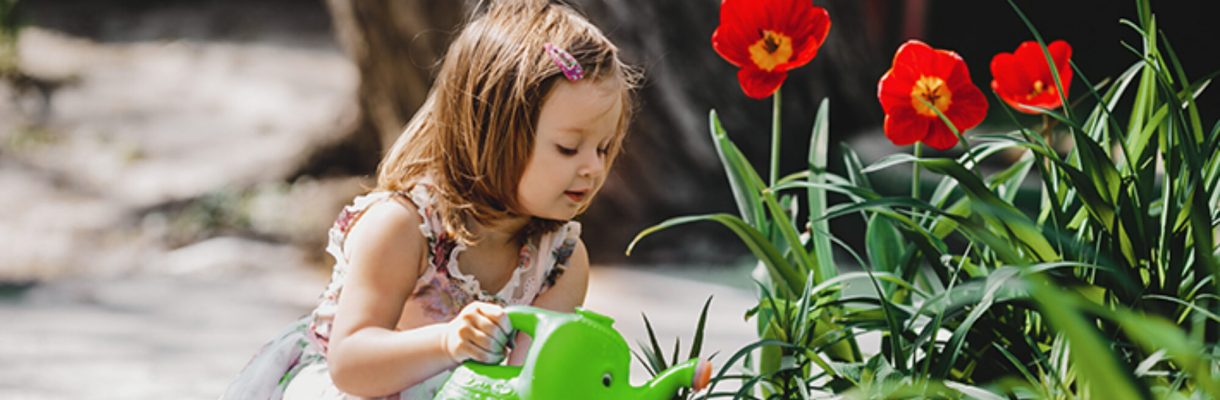cropped-charming-little-girl-takes-care-about-flowers-garden_.jpg
